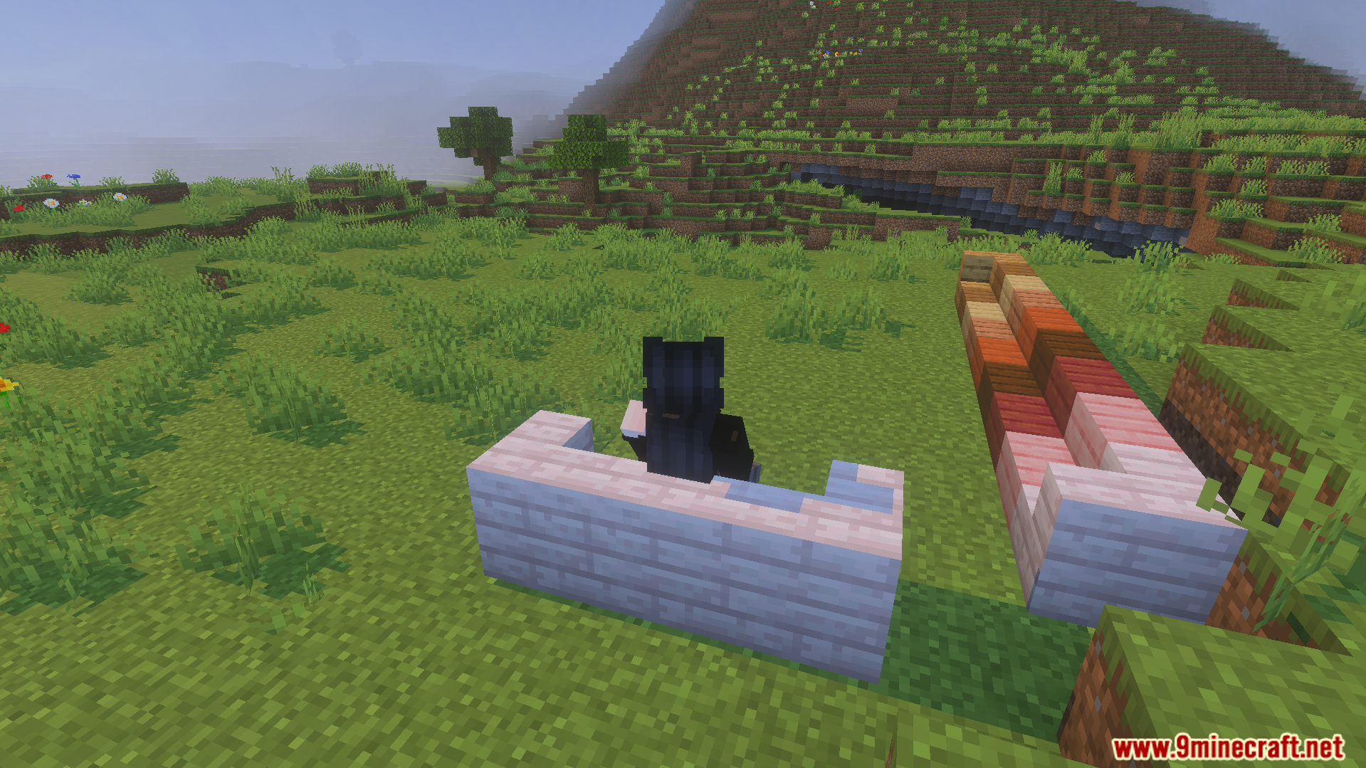 A player sitting on white wooden stairs using the Take A Seat Addon