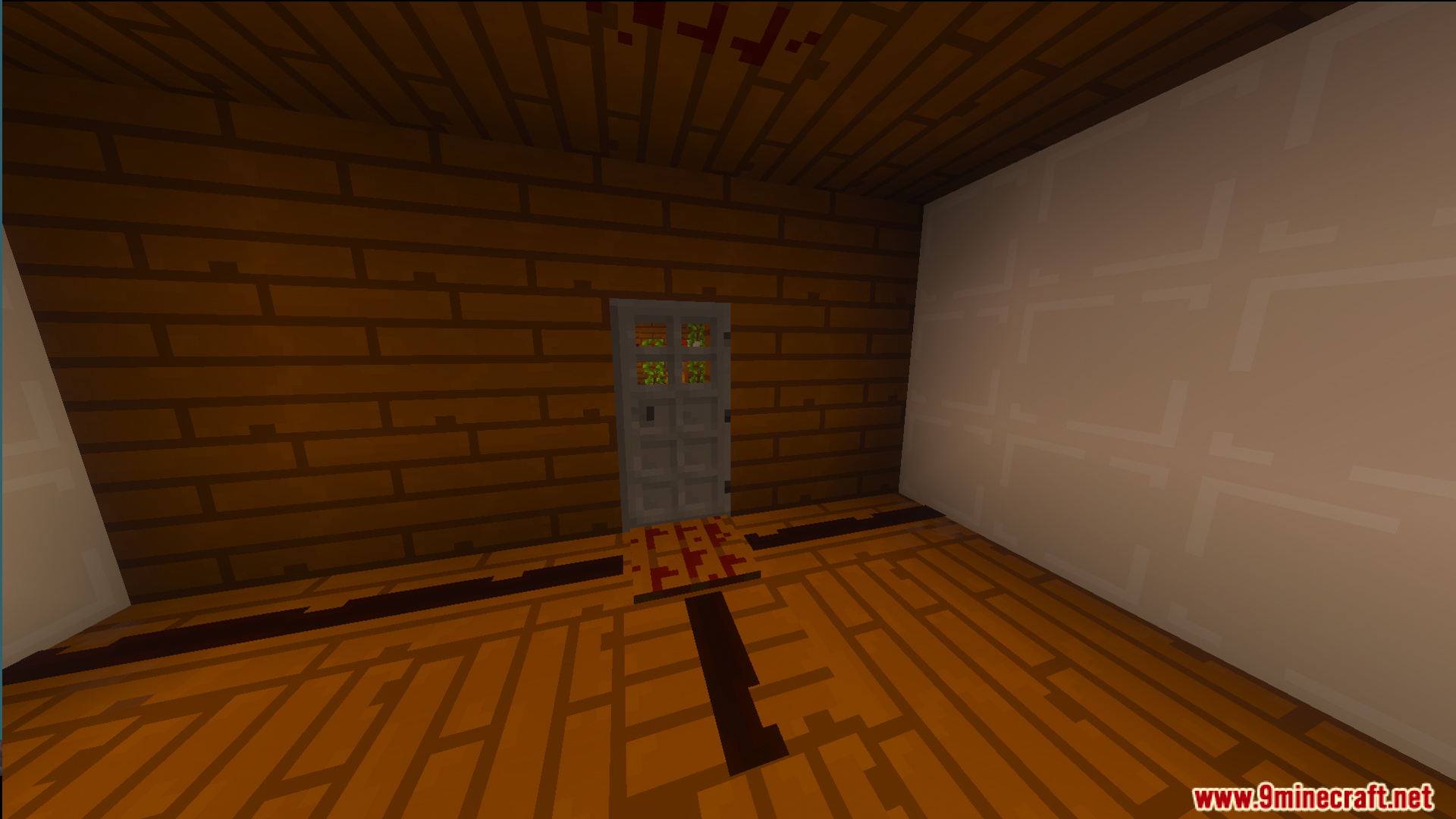 Wooden room with a gray door and a white wall inside a house