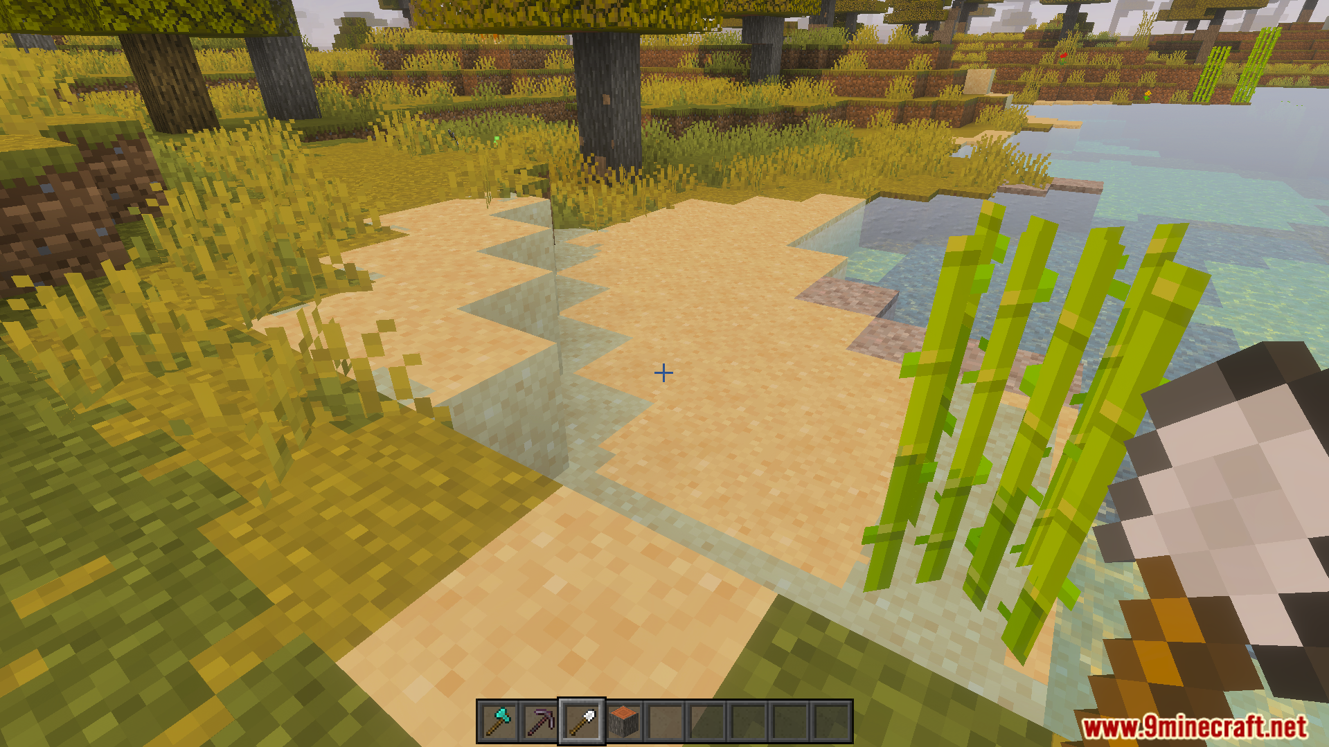 VeinMiner Tree Capitator Addon Screenshot 8 Minecraft player using a shovel to quickly clear sand blocks on a beach