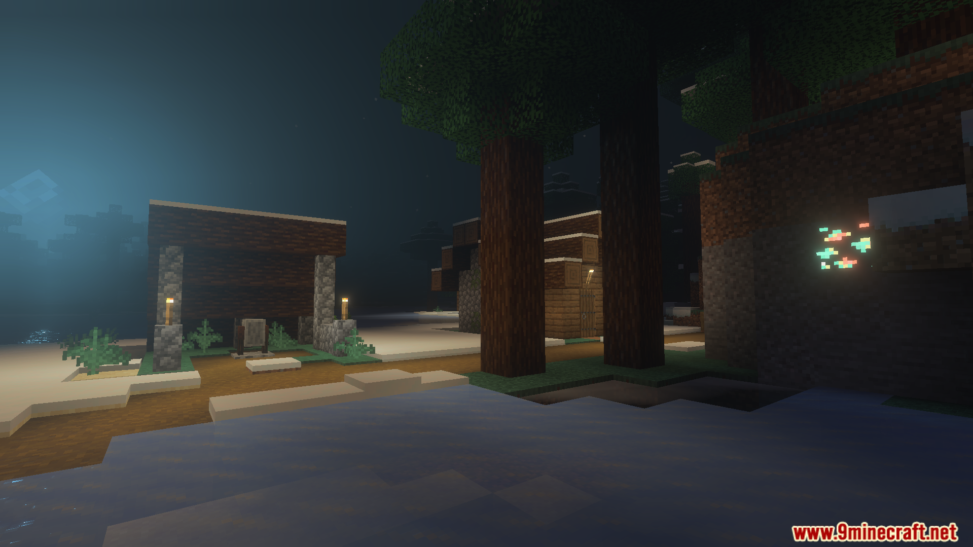 Nighttime view of a village with glowing ores and lanterns
