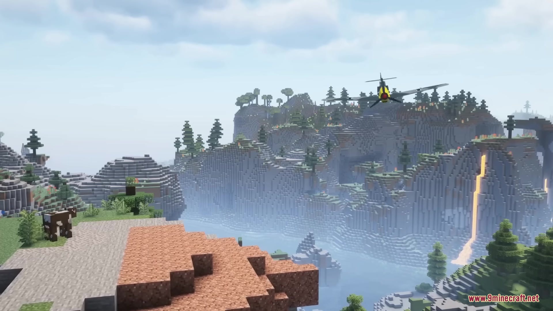 Warfare Wings Mod Screenshot 16 A military aircraft flies over a scenic Minecraft mountain landscape with waterfalls